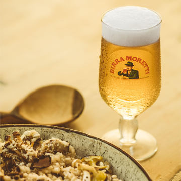 Birra Moretti and a truffle dish on the table